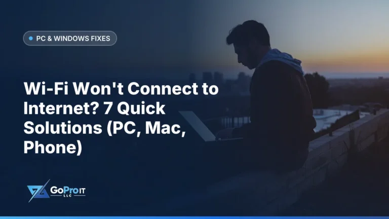Person working on a laptop outdoors at dusk above a city