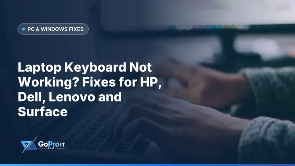 Hands typing on a laptop keyboard beside a blurred desk monitor