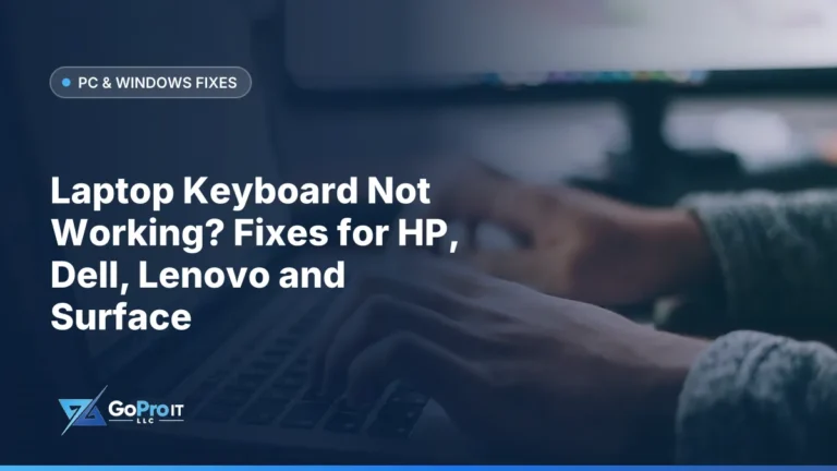 Hands typing on a laptop keyboard beside a blurred desk monitor
