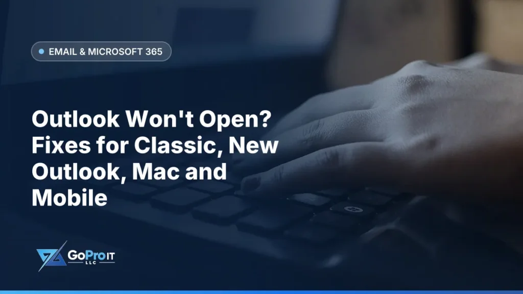 Hand resting on the keyboard of a dark laptop in dim light
