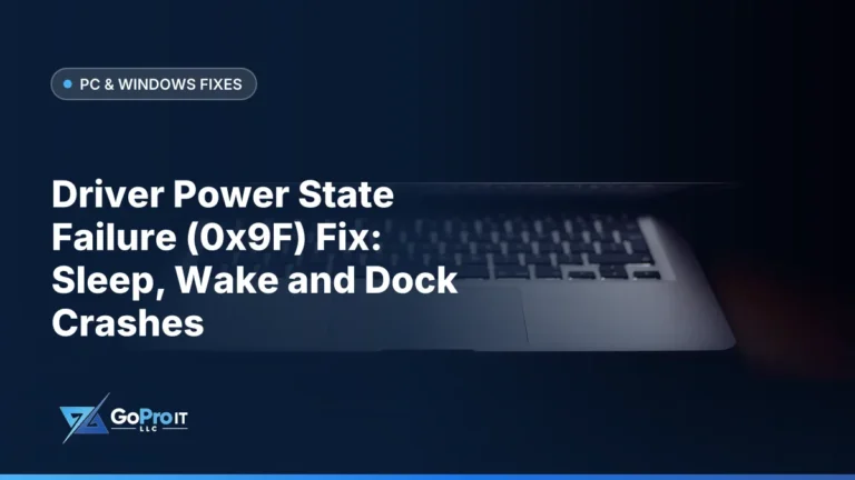 Half-open laptop with its keyboard faintly glowing in a dark room