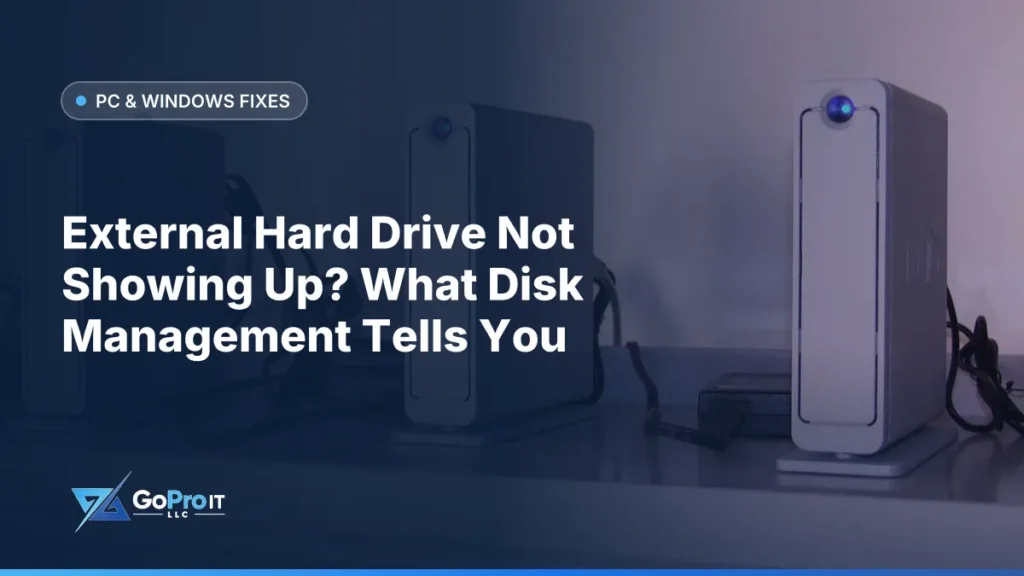 Row of silver external hard drives with blue lights on a shelf