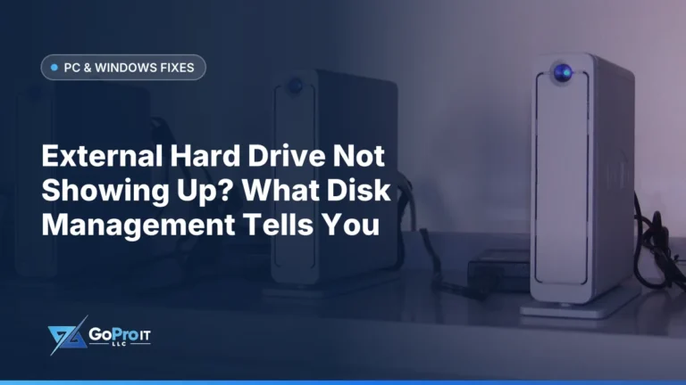 Row of silver external hard drives with blue lights on a shelf